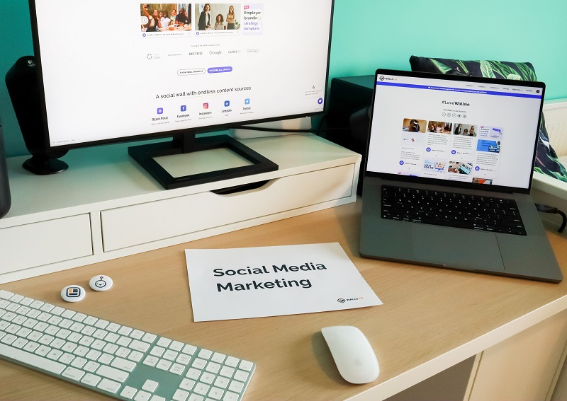 Modern workstation displaying viral marketing content and social media marketing tools on desktop and laptop screens.
